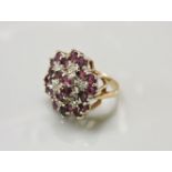 A 9ct gold illusion set diamond and ruby cluster ring