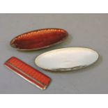 A Continental silver and red enamel comb, and two David Andersen silver and enamel oval dishes