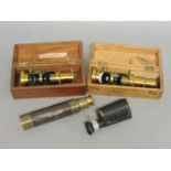 Two brass monocular microscopes in wooden boxes, a two draw telescope, and a monocular