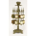 A Victorian brass three tier cotton reel stand, with a pin cushion top and pierced fretwork tiers,