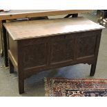 A 17th century oak coffer, with original carved three panel front, 124cm wide, 55cm deep, 76cm high