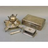 A silver cigarette lighter/ashtray, silver cigarette box, a vesta sleeve, and a cheroot case