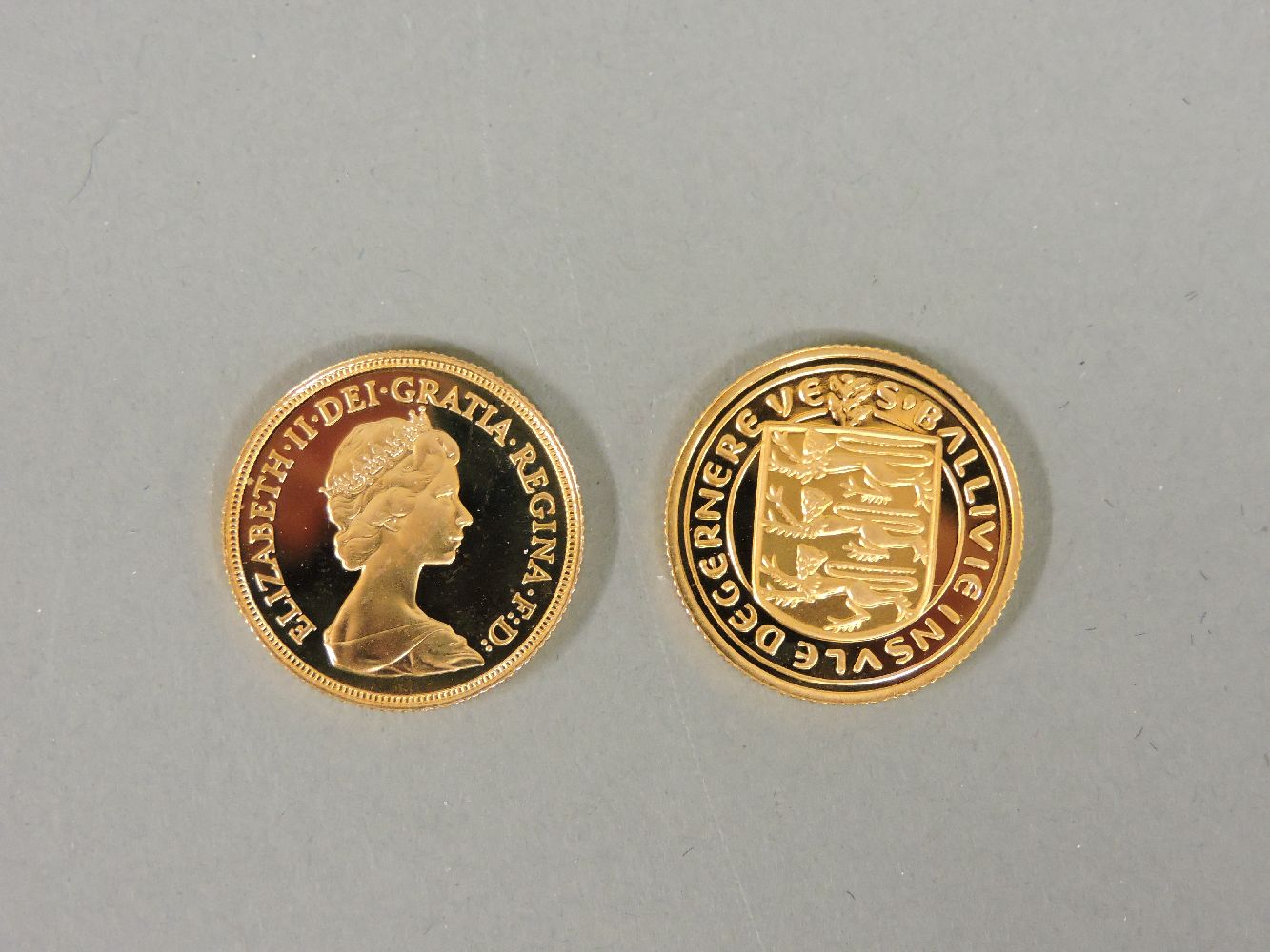 A 1980 proof gold sovereign, together with a 1981 Guernsey gold one pound coin - Image 2 of 3