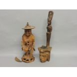 A Chinese figure of a monk, his left hand with a fly whisk and a rosary in his right hand, and