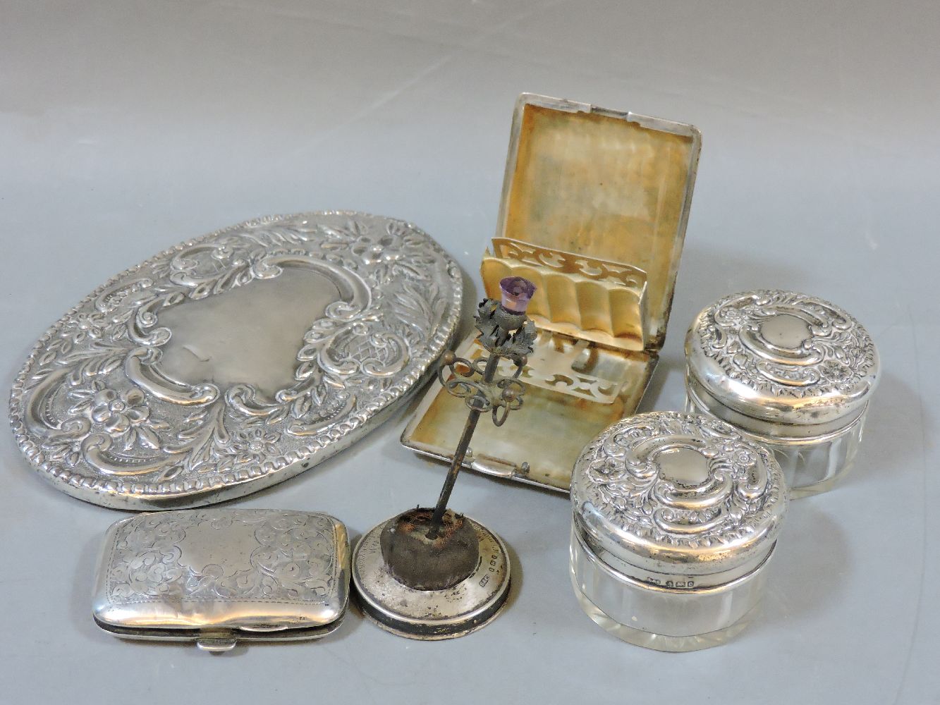 Silver items, to include two dressing table jars, a sterling cigarette case, etc