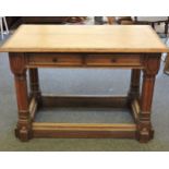 A Victorian Gothic revival oak library table, inset tooled leather top, above two drawers, supported