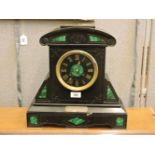 A Victorian black slate malachite inset mantel clock