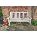 A teak garden bench, with slatted back and seat, 160cm wide