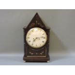 A Regency period mahogany mantel clock, with pointed top and brass inlay, the convex dial with