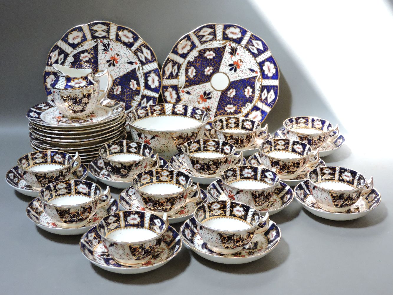 Staffordshire Imari tea wares, including a Royal Crown Derby plate, mixed porcelain cups and
