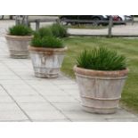 Three large terracotta planters, of tapering form, each 70cm diameter, 60cm high