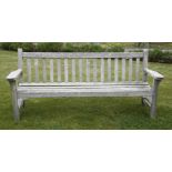 A teak garden seat, with slatted back and open arms, 190cm wide, and another smaller