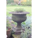 A Regency style cast iron campana urn, square stepped base, approximately 52cm high overall