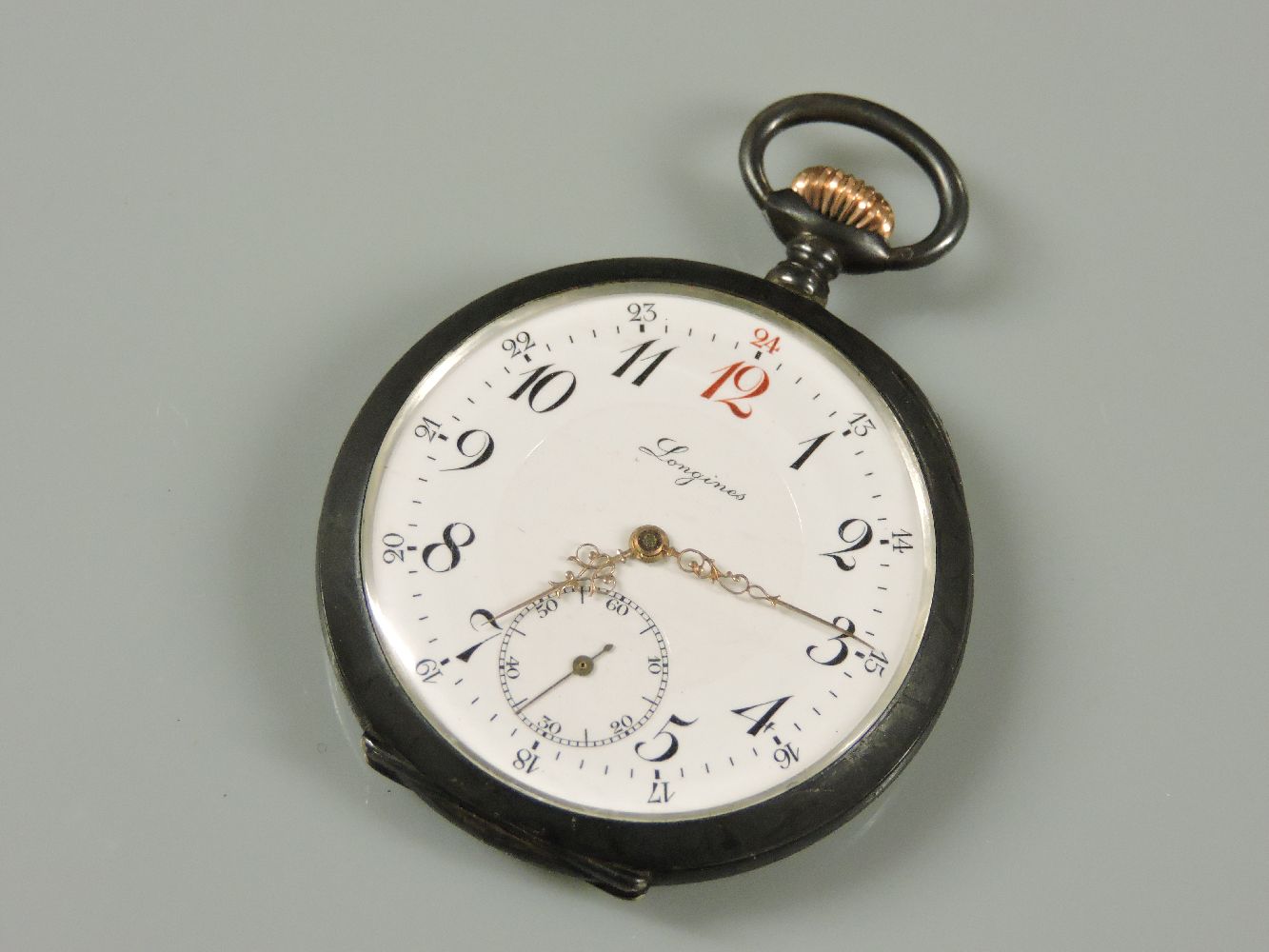 A Longines cracked ice design back base gun metal and gold plated open faced pocket watch, with