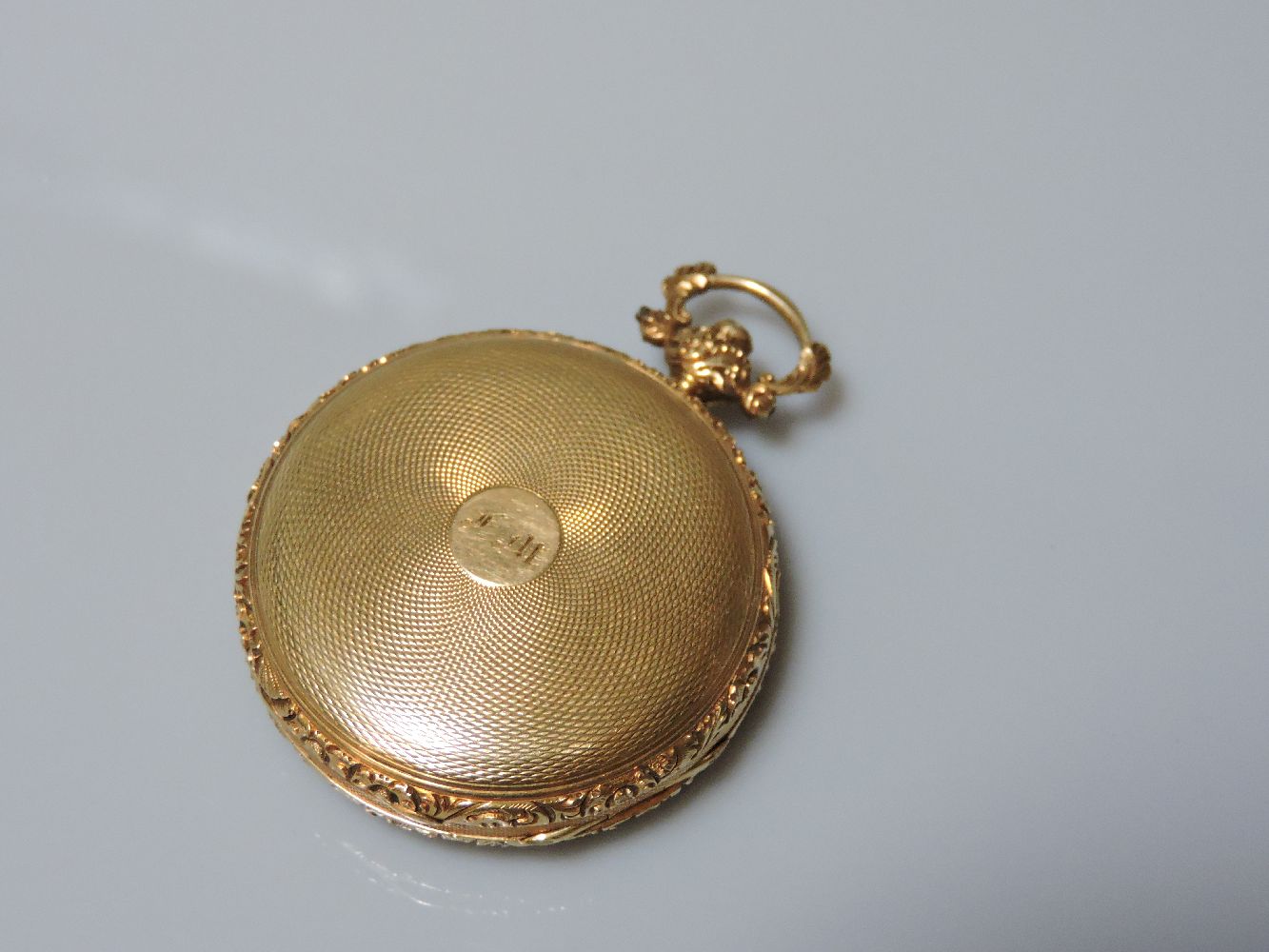 An 18ct gold key wound open faced pocket watch, with gold engine turned dial with three colour - Bild 2 aus 2