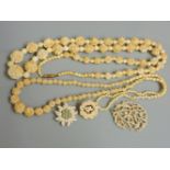 A single row of graduated carved ivory flower head bead and beads, a single strand of graduated