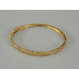 A Continental gold Greek key hinged bangle, stamped 585, 7.9g