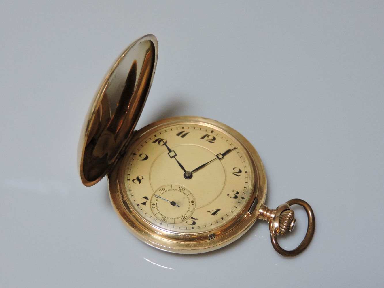 A Swiss full hunter gold pocket watch, with sun ray engine turned decoration to both covers,