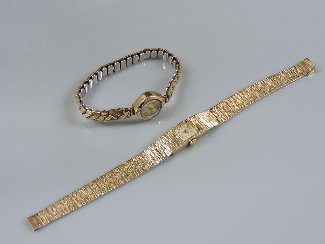 A 9ct gold ladies Berkeley mechanical bracelet watch, with raised gold batons on a bark textured