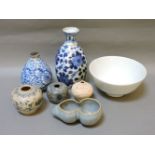 Five small Oriental vases, decorated in blue and white or unglazed, a 'ru' brush washer, and a white