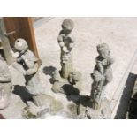 Three reconstituted stone garden ornaments of children, on cast column supports