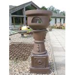 Two bronze glazed terracotta planters, with tapering supports and square bases