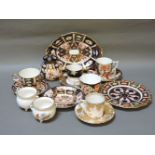 A collection of Royal Crown Derby tea wares, including cups and saucers, plates, dishes, and a pot