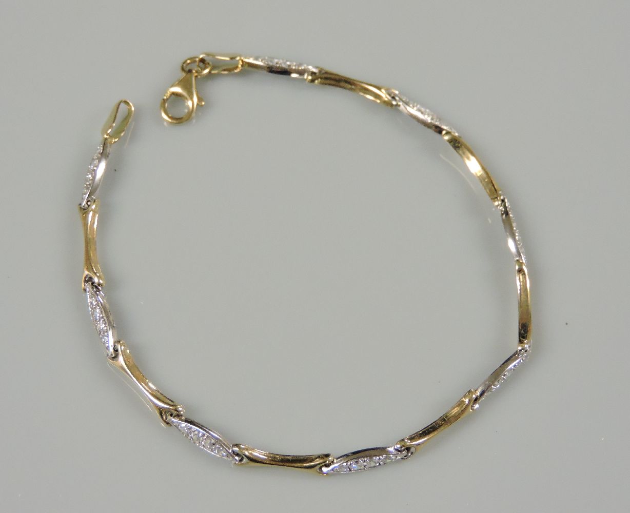 A 9ct gold two colour gold cubic zirconia set bracelet