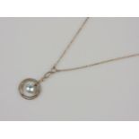 An Edwardian gold blue topaz two row circle pendant, on chain