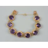 A 9ct gold synthetic colour change corundum bracelet, mounted in twisted rope mounts