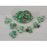 A malachite set overhand knot brooch, damaged, and a silver and malachite shamrock bracelet with