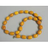 A single row bakelite barrel and silver plated bead necklace