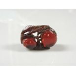 A bakelite carved pendant, of peaches in foliate