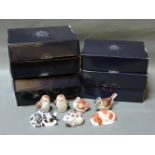 Seven Royal Crown Derby Collector's Guild member's packs, each containing porcelain paperweight,