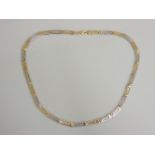A two coloured gold Greek key link necklace, marked 585, 8.53g
