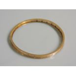 An Art Deco 9ct gold four row bangle, 11.24g