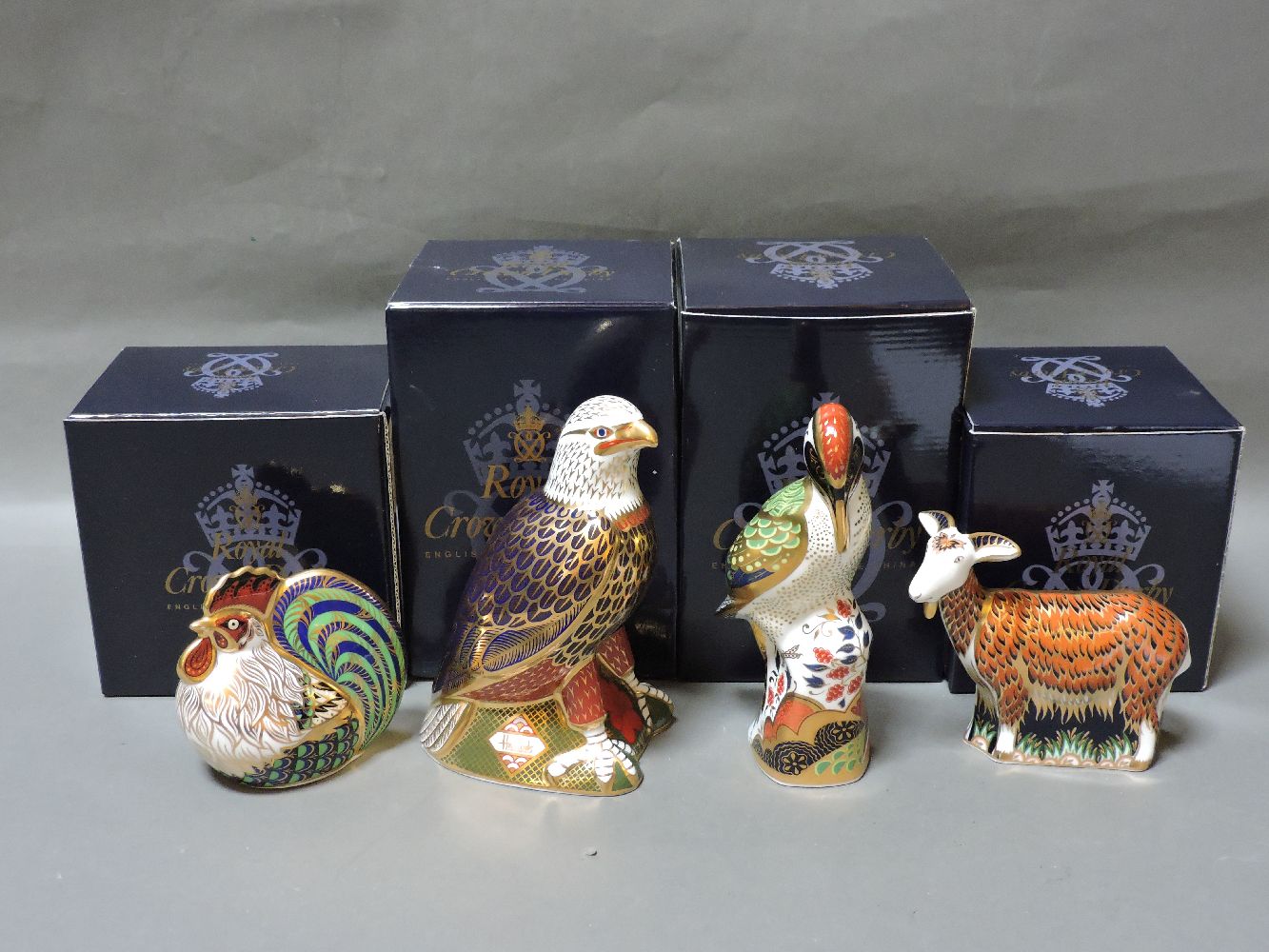 Four various Royal Crown Derby porcelain paperweights, to include Bald Eagle 264/300, Nanny Goat,