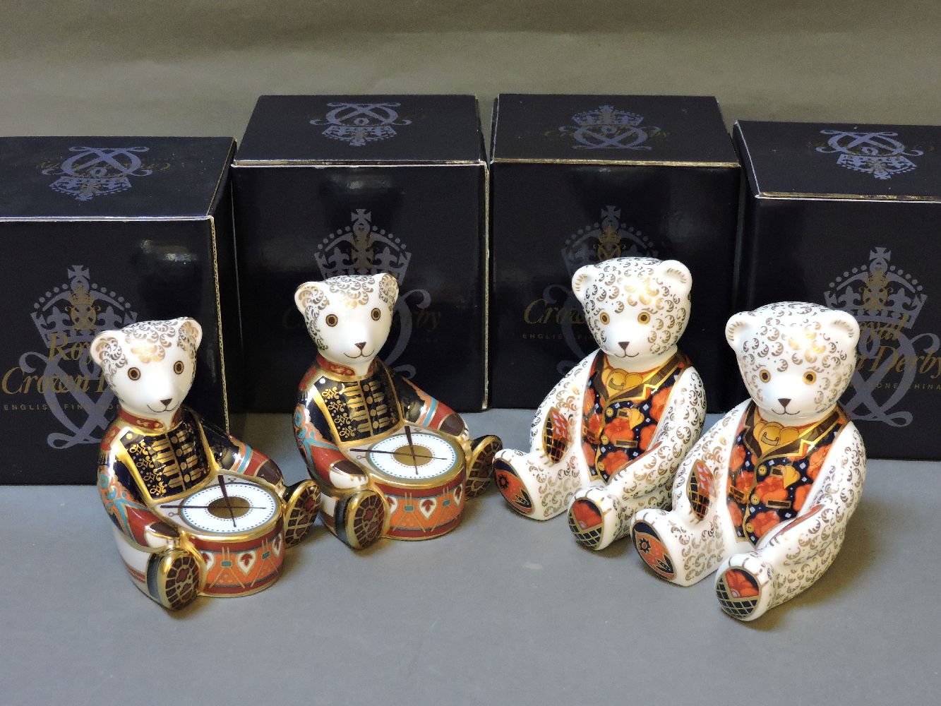 Four various Royal Crown Derby porcelain paperweights, to include two copies of Debonair Bear, and