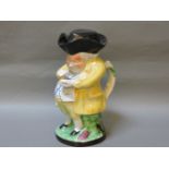 A 19th century Toby jug, snuff taker in a yellow jacket and spotted waistcoat in a black tricorn