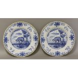 A pair of mid 18th century Delft blue and white plates, decorated with sheep in a naturalistic