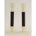 A pair of ivory and composition candlesticks,early 20th century, with ivory sconces and bases, and
