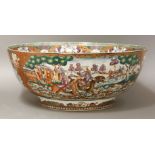 A Mandarin palette Punch Bowl,c.1760, richly painted on the exterior with two panels of European