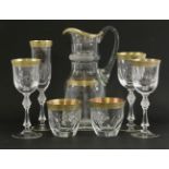 A suite of cut and faceted Glassware,with gilt rims, engraved with scrolling floral design, to