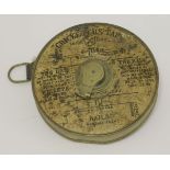 A 'Cricketers' Tape',with a printed paper front and brass body,10cm diameter