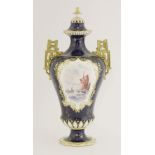 A Royal Crown Derby Vase and Cover, dated 1910, with painted panels of boats, on a blue ground,