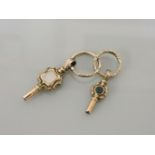 Two gold cased watch keys, set with foiled gemstones, with gold chased split rings, circa 1843, 8.