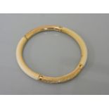 A 19th century ivory slave bangle, with gold chased sections