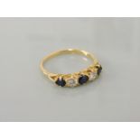 A gold five stone sapphire and diamond ring, stamped 18ct, 3.2g