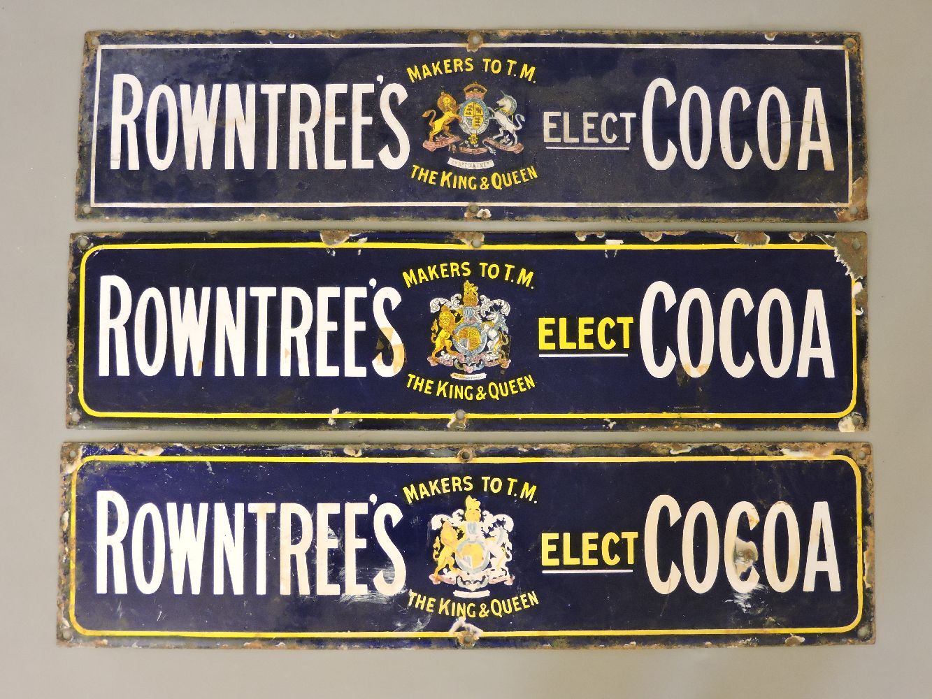 Three 'Rowntree's Cocoa' enamel tin signs, navy ground with yellow and blue writing
