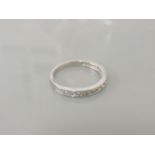 An 18ct white gold half hoop diamond eternity ring